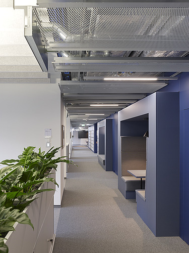 The Z2.0 office corridor with office plants and seating for discussions.