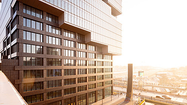 Das Bild zeigt das Erdgeschoss des EDGE East Side Tower am Bahnhof Warschauer Straße in Berlin während des Sonnenaufgangs.