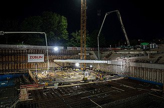 Die anspruchsvolle Baugrube in der Dunkelheit und Flutlicht der Baustrahler.
