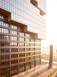 The façade of the EDGE East Side Tower at sunrise.