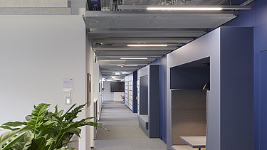 The Z2.0 office corridor with office plants and seating for discussions.