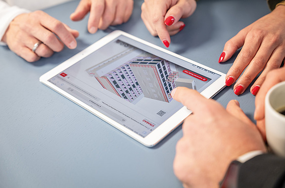 Auf dem Bild sieht mein ein Tablet auf einem Tisch, auf welchem ein digitales Gebäudemodell zu sehen ist.