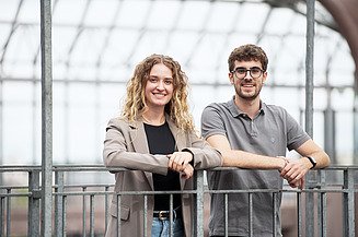Two working students in civil engineering at Zentrale Technik are standing in the ZÜBLIN building.